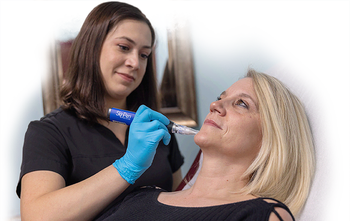 Amanda using SkinPen on a patient's face to reduce wrinkles